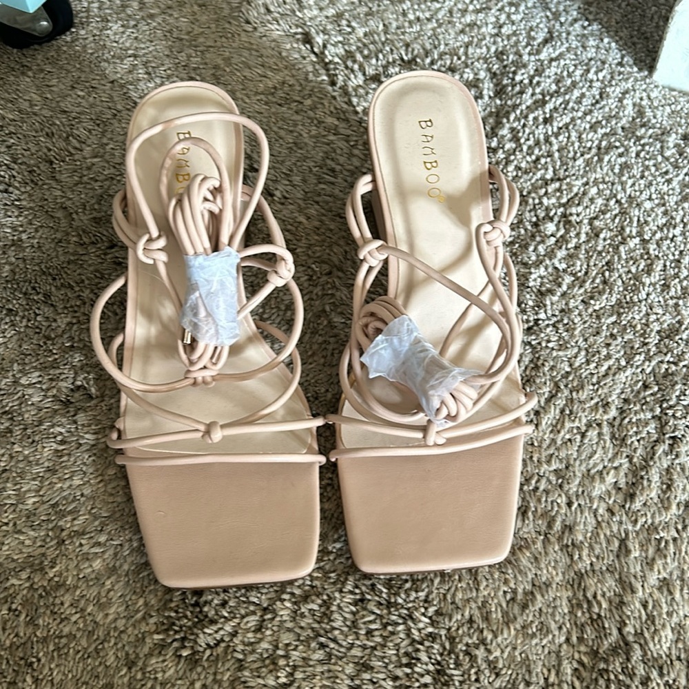 Nude bamboo brand new heals still with strings wrapped up. Size 8